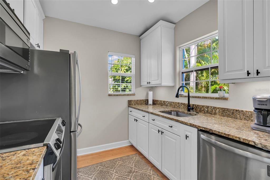 An aerial view shows a residential property marked with a pin near a coastal beach — 564 70TH AVENUE, ST PETE BEACH, FL