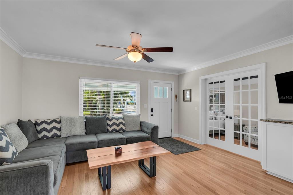 A kitchen features white cabinets, granite countertops, stainless steel appliances, and two windows — 564 70TH AVENUE, ST PETE BEACH, FL