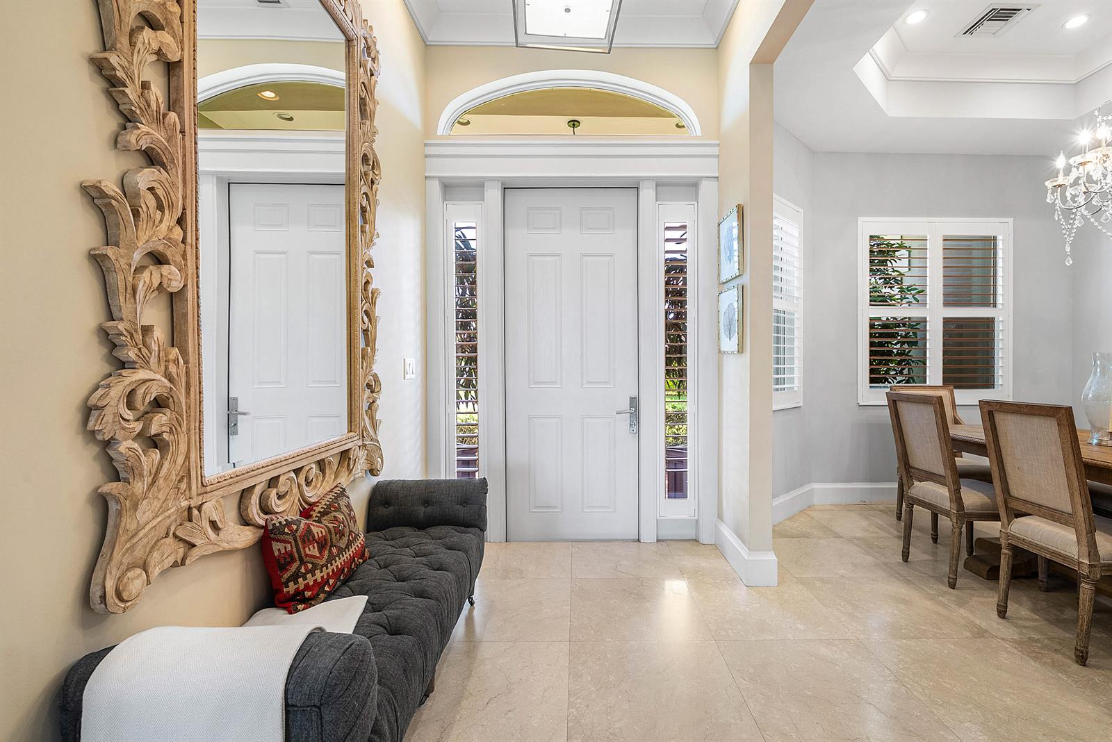 A foyer features a tufted bench, a large ornate mirror, and a white front door — 33 Spanish River Drive, Ocean Ridge FL 33435, OCEAN RIDGE, FL