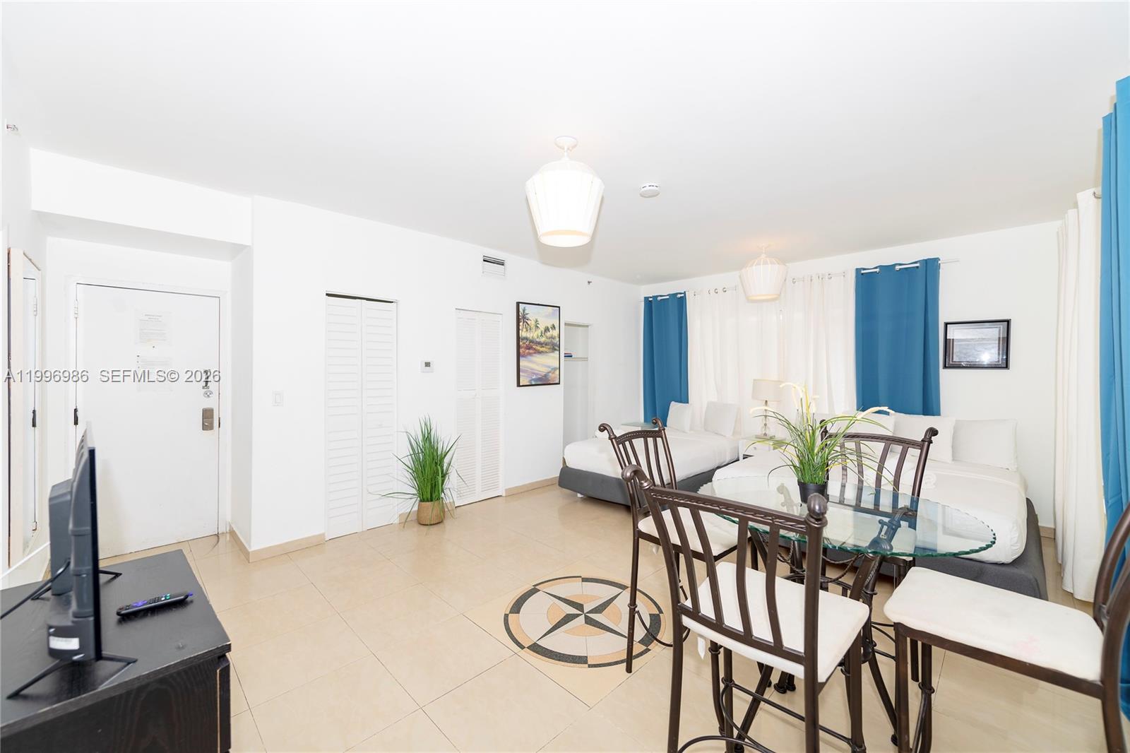 A studio apartment features a dining table, two beds, and tile flooring — 918 Ocean Dr # 203, Miami Beach FL 33139, MIAMI BEACH, FL