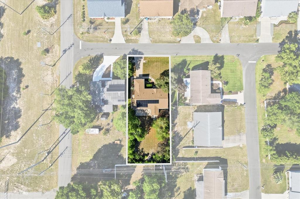 This aerial view shows a residential property with a house and backyard enclosed by trees — 966 W STARJASMINE PLACE, BEVERLY HILLS, FL