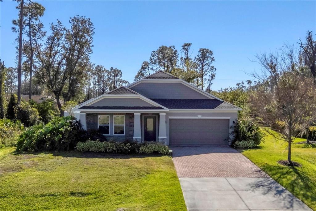 A single-story house with a gray exterior, a two-car garage, and a paved driveway — 2179 W PRICE BLVD, NORTH PORT, FL