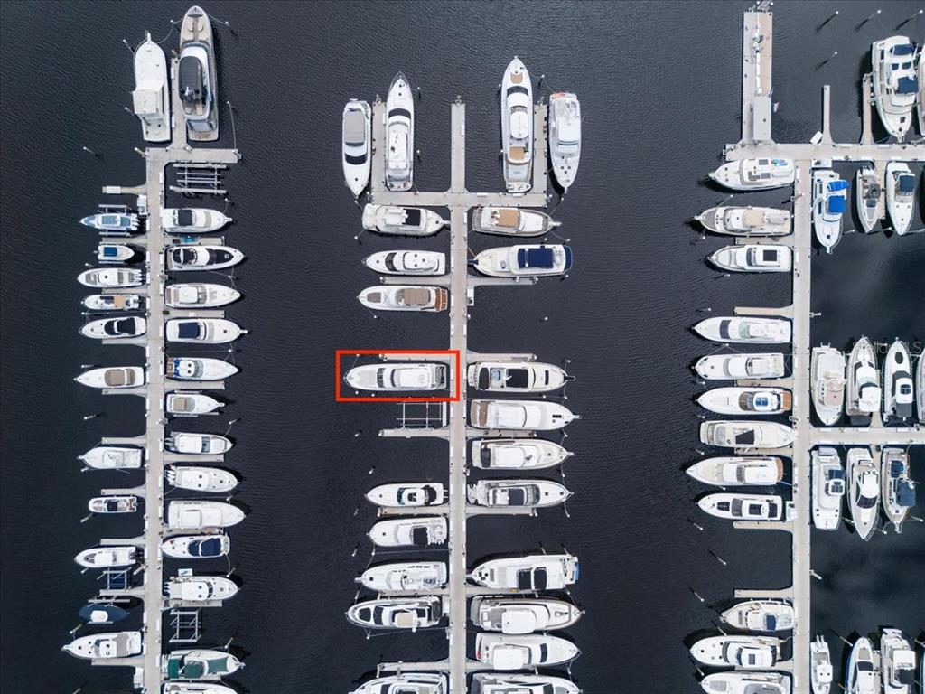 An aerial view shows numerous boats docked in slips at a marina — 102 RIVIERA DUNES WAY UNIT C-22, PALMETTO, FL