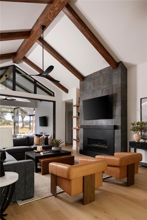 A living room features vaulted ceilings with wood beams, a tiled fireplace, and leather chairs — TBD NW 150TH BOULEVARD, NEWBERRY, FL