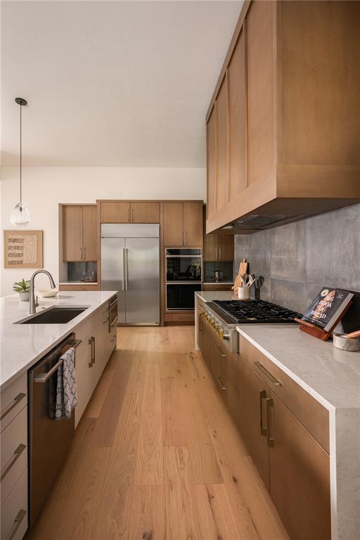 A modern kitchen features light wood cabinets, stainless steel appliances, and a large white island — TBD NW 150TH BOULEVARD, NEWBERRY, FL