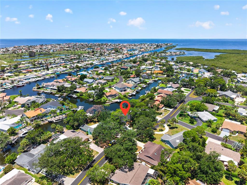 An aerial view shows a residential neighborhood with houses, canals, and a red location pin — 4346 MARINE PARKWAY, NEW PORT RICHEY, FL