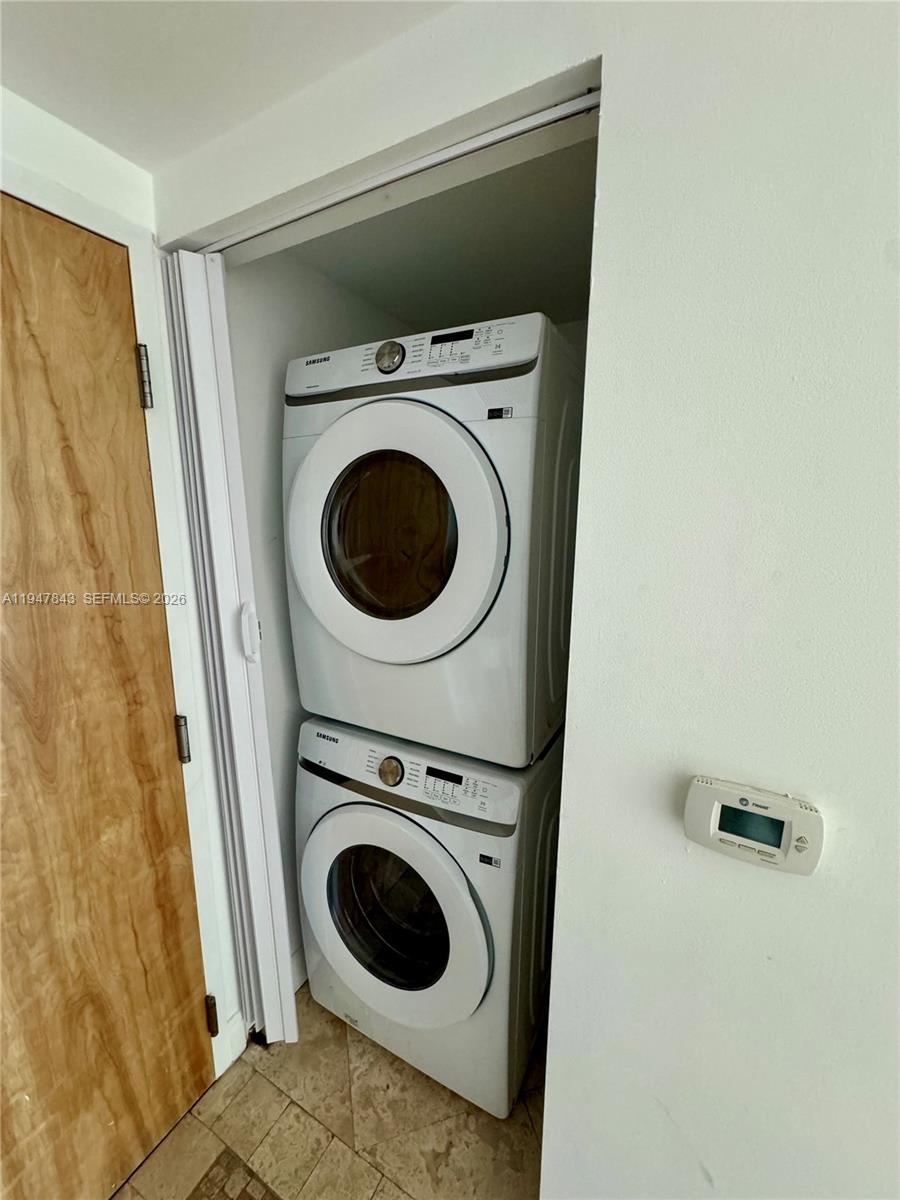 A stacked Samsung washer and dryer unit sits inside a small closet — 350 S Miami Ave # 3008, Miami FL 33130, MIAMI, FL
