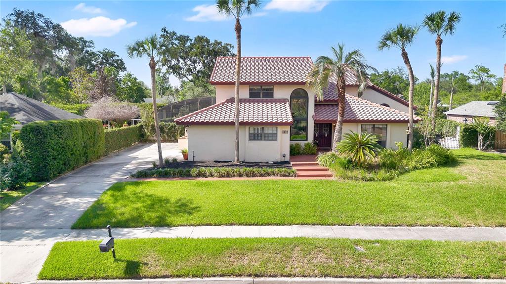 A kitchen with white cabinets, granite countertops, a breakfast bar, and a view of a patio — 1367 CAMPBELL STREET, ORLANDO, FL