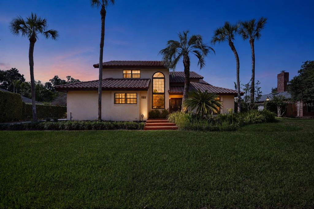 An entryway features a wooden double door, a carpeted staircase, and light-colored tile flooring — 1367 CAMPBELL STREET, ORLANDO, FL