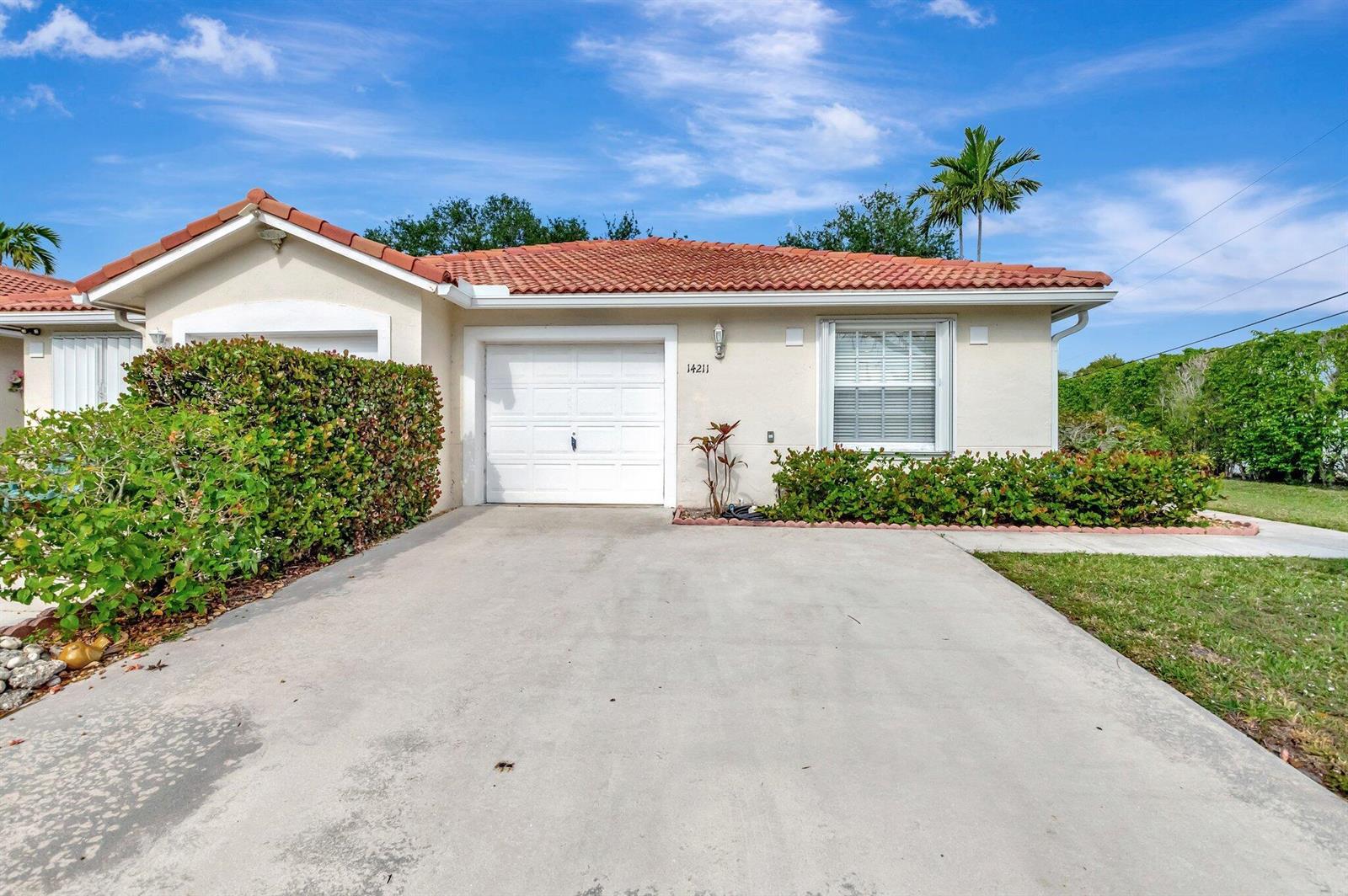 A single-story house with a white garage, a tiled roof, and a concrete driveway — 14211 W La Sedona Circle, Delray Beach FL 33484, DELRAY BEACH, FL