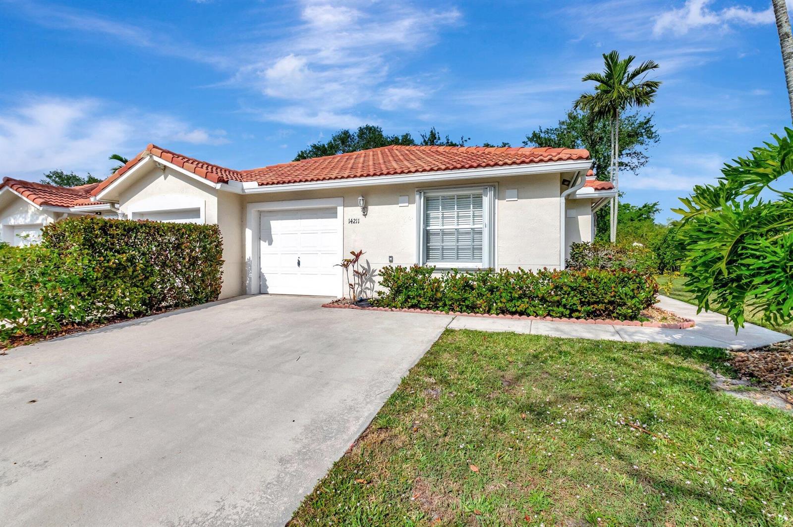 A single-story house with a white garage, tiled roof, and landscaped front yard — 14211 W La Sedona Circle, Delray Beach FL 33484, DELRAY BEACH, FL