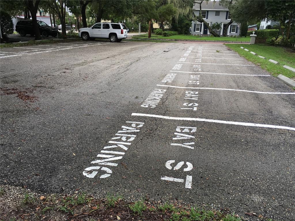 An outdoor parking lot with painted spaces and a white SUV in the background — 611 W BAY STREET, TAMPA, FL