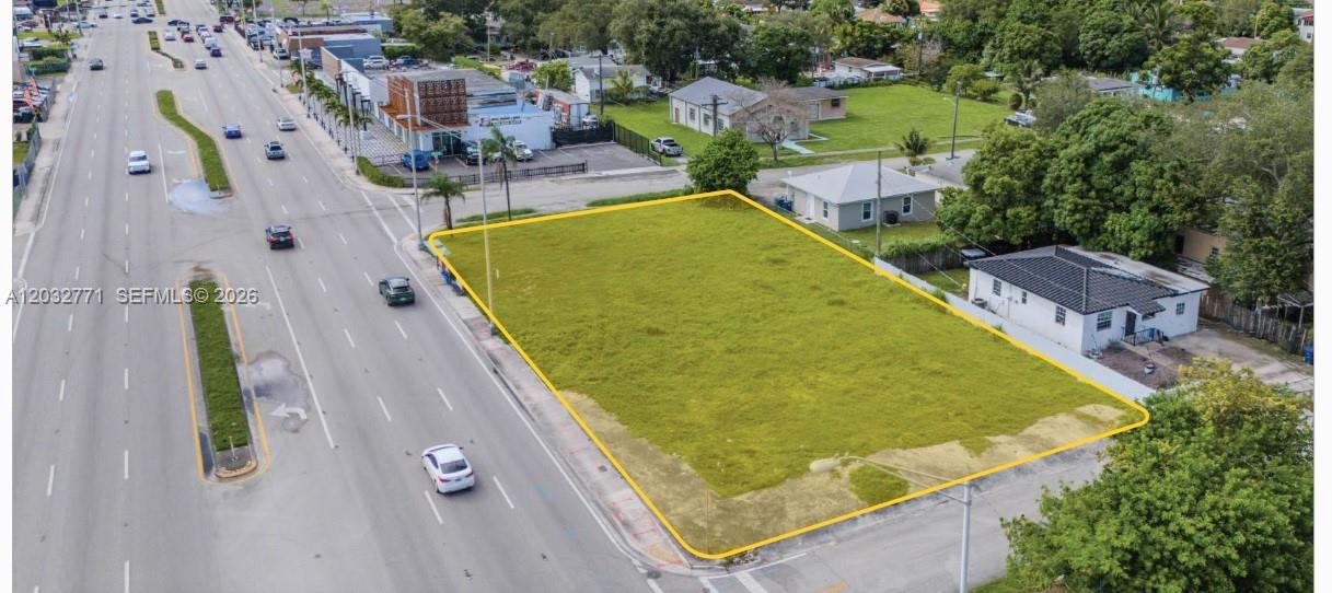 An aerial view shows a vacant, rectangular grass lot bordered by a road and houses — 1477 NW 79th St, Miami FL 33147, MIAMI, FL
