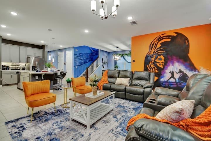 A living room features a Star Wars mural, gray leather furniture, and an orange armchair — 1919 TROPICAL PALMS CIRCLE, KISSIMMEE, FL