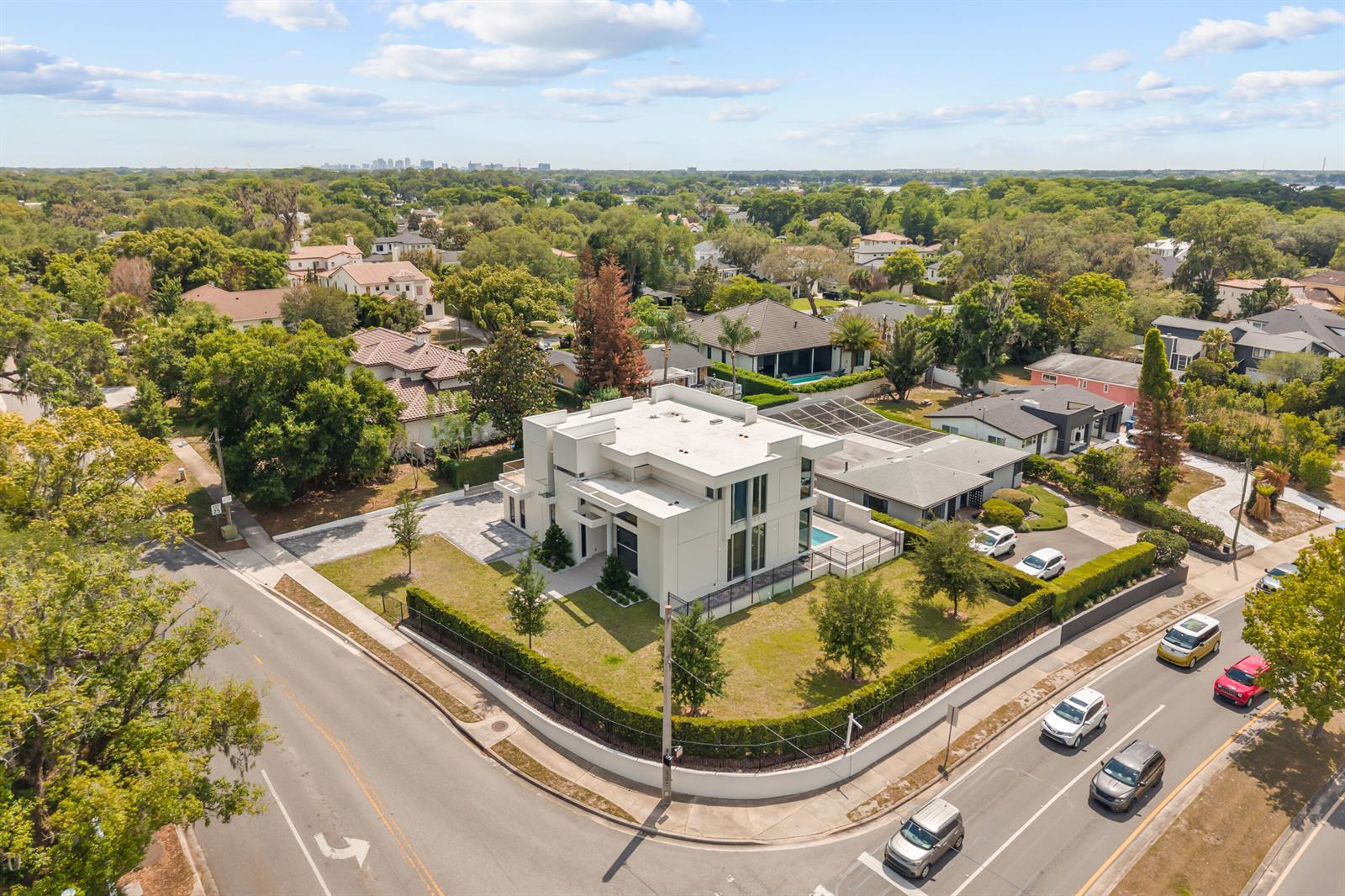 An aerial view shows a modern white house with a flat roof on a corner lot — 2661 Via Tuscany, Winter Park FL 32789, WINTER PARK, FL