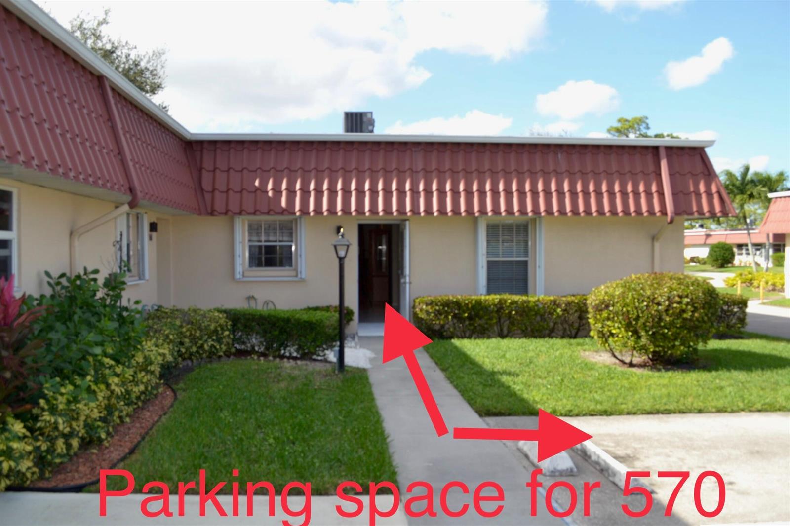 A single-story residential unit features a red mansard roof, a screened porch, and landscaping — 570 Laconia Circle, Lake Worth FL 33467, LAKE WORTH, FL