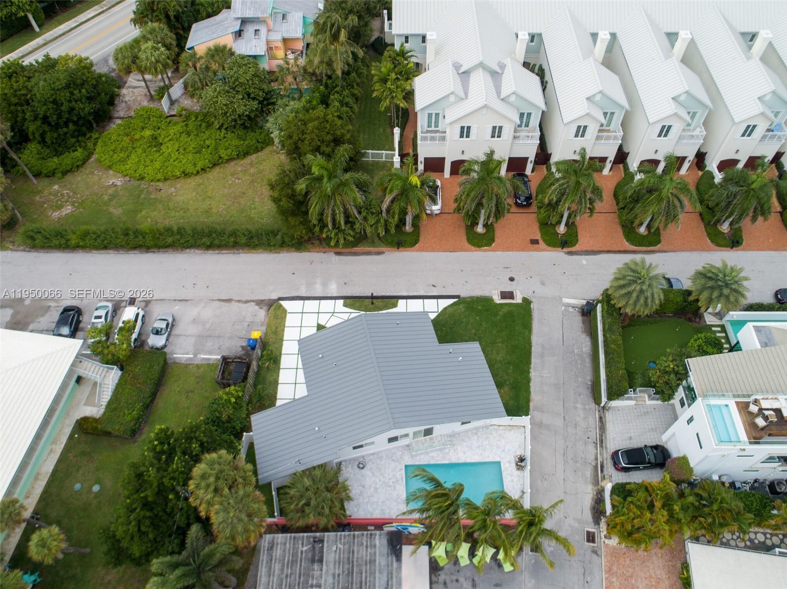 An aerial view shows a house with a gray metal roof and a backyard pool — 12 Adams Road, Ocean Ridge FL 33435, OCEAN RIDGE, FL
