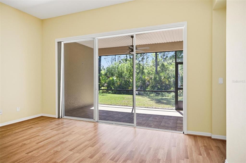 A kitchen features wood cabinets, black appliances, tile flooring, and a double-basin sink — 144 MENDOZA CIRCLE, DAYTONA BEACH, FL