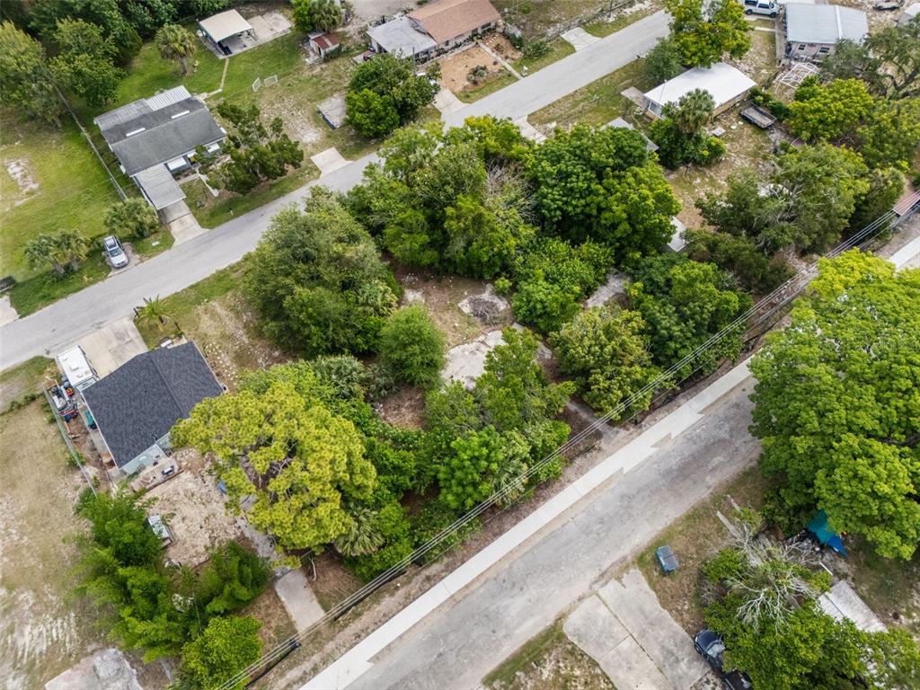 An aerial view shows a vacant, tree-covered lot situated between two residential streets — 7039 JOHNSON ROAD, PORT RICHEY, FL
