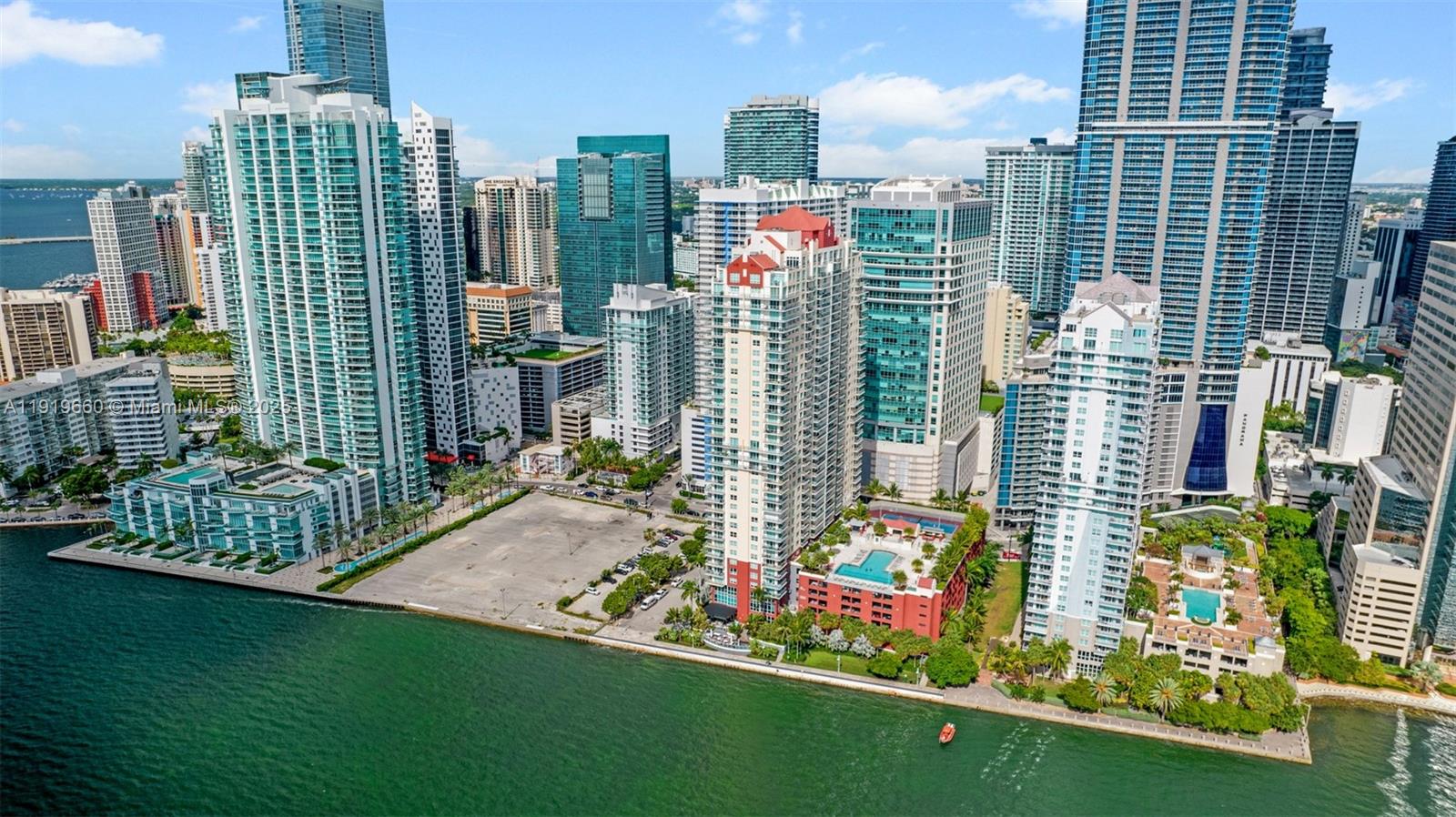 An aerial view shows high-rise apartment buildings along a waterfront in a city — 1155 Brickell Bay Dr # 2203, Miami FL 33131, MIAMI, FL