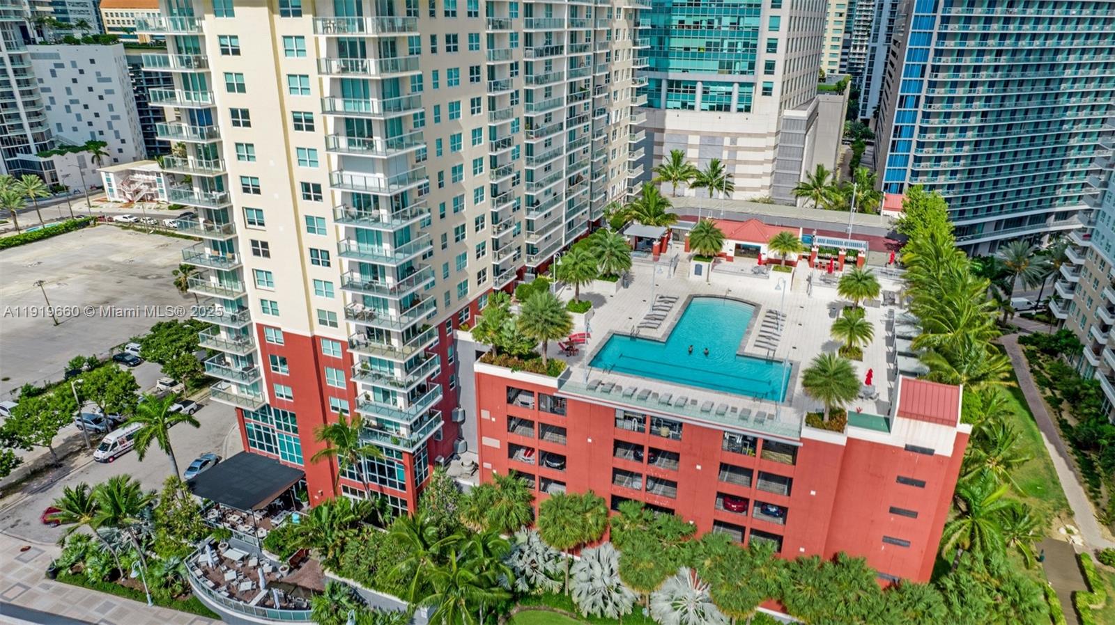 An aerial view of a high-rise apartment building featuring a rooftop pool and parking garage — 1155 Brickell Bay Dr # 2203, Miami FL 33131, MIAMI, FL