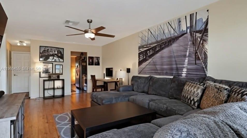 A living room features a large gray sectional sofa, a coffee table, and wall art — 8069 SW 19th Ct, Davie FL 33324, DAVIE, FL