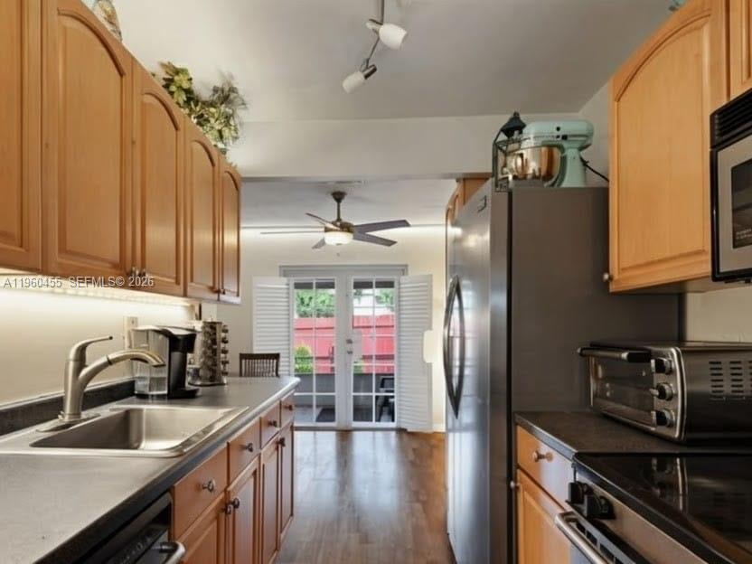 A kitchen with wood cabinets, stainless steel appliances, and a view of a patio door — 8069 SW 19th Ct, Davie FL 33324, DAVIE, FL