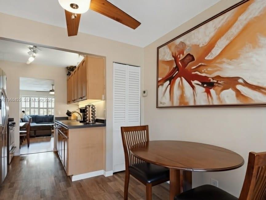 A dining area with a wooden table and chairs next to a kitchen with cabinets — 8069 SW 19th Ct, Davie FL 33324, DAVIE, FL