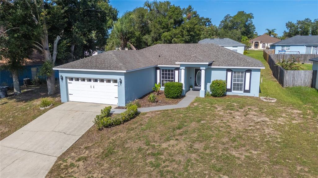 An aerial view of a light blue single-story house with a two-car garage and lawn — 6059 HILLSIDE HEIGHTS DRIVE, LAKELAND, FL