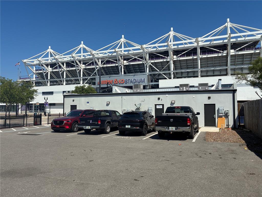 A parking lot sits in front of a stadium with a large white metal structure — 646 W CHURCH STREET, ORLANDO, FL