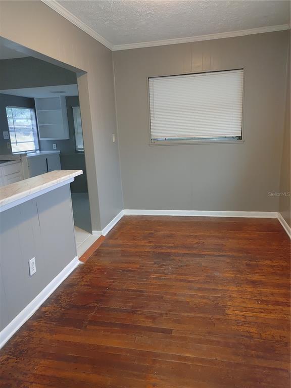 A dining area features hardwood floors, gray walls, and a window with white blinds — 1090 SAINT CLAIR STREET, JACKSONVILLE, FL
