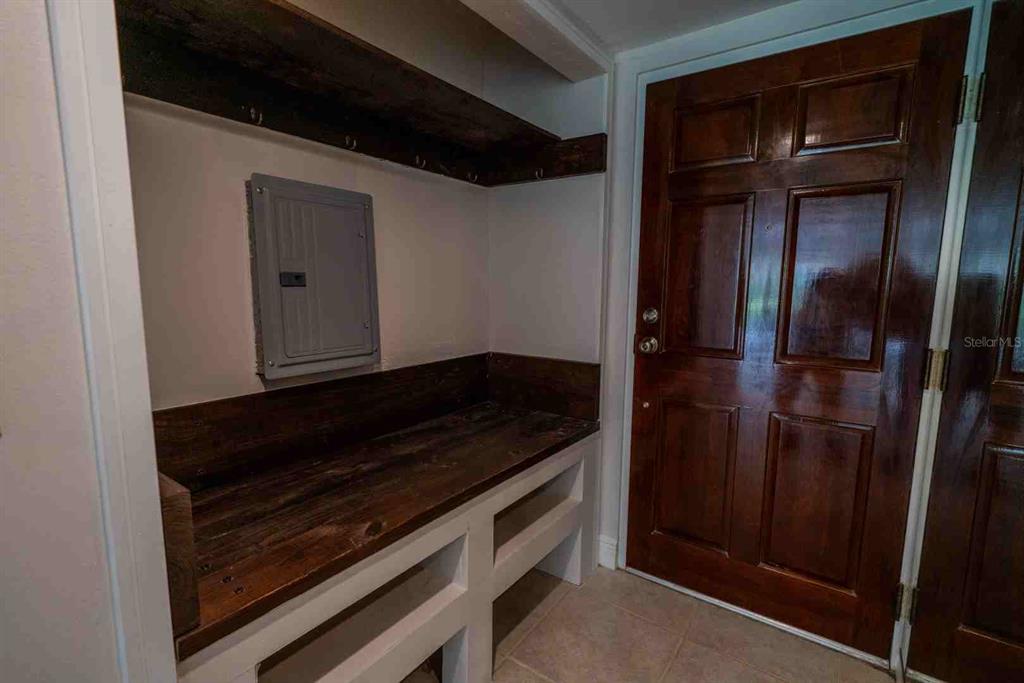 A dining area and kitchen island with tile flooring and large sliding glass doors — 225 COUNTRY CLUB DRIVE UNIT D142, LARGO, FL