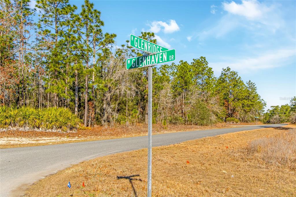 A street sign stands at the intersection of two paved roads near a wooded area — 6932 N GLENRIDGE CIRCLE, CITRUS SPRINGS, FL