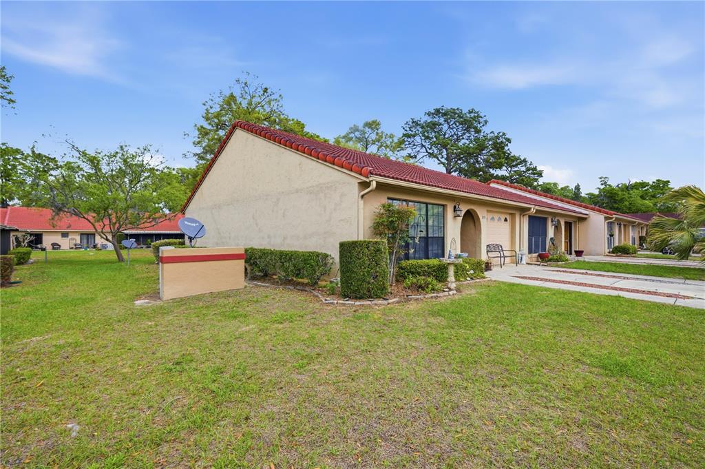 A single-story stucco townhouse with a red tile roof and a front lawn — 3455 SW 19TH STREET, OCALA, FL