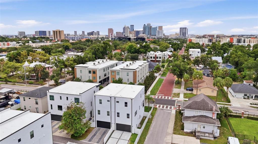 An aerial view of modern townhomes and surrounding houses with a city skyline in the background — 215 W COLUMBUS DRIVE UNIT 2, TAMPA, FL