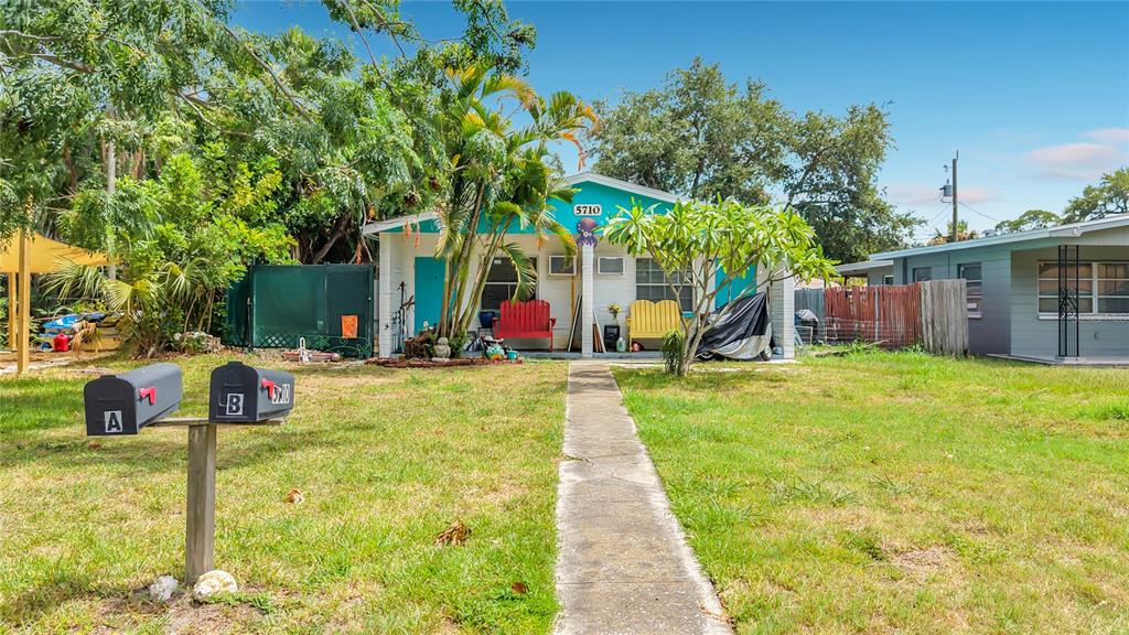 A single-story house with a teal roof, two front doors, and two mailboxes in front — 5710 19TH AVENUE S, GULFPORT, FL