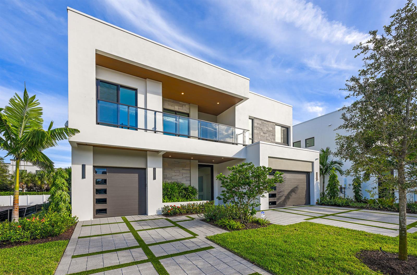 A modern two-story house with a white exterior, glass balcony, and two garage doors — 16709 Mosaic Place, Delray Beach FL 33446, DELRAY BEACH, FL