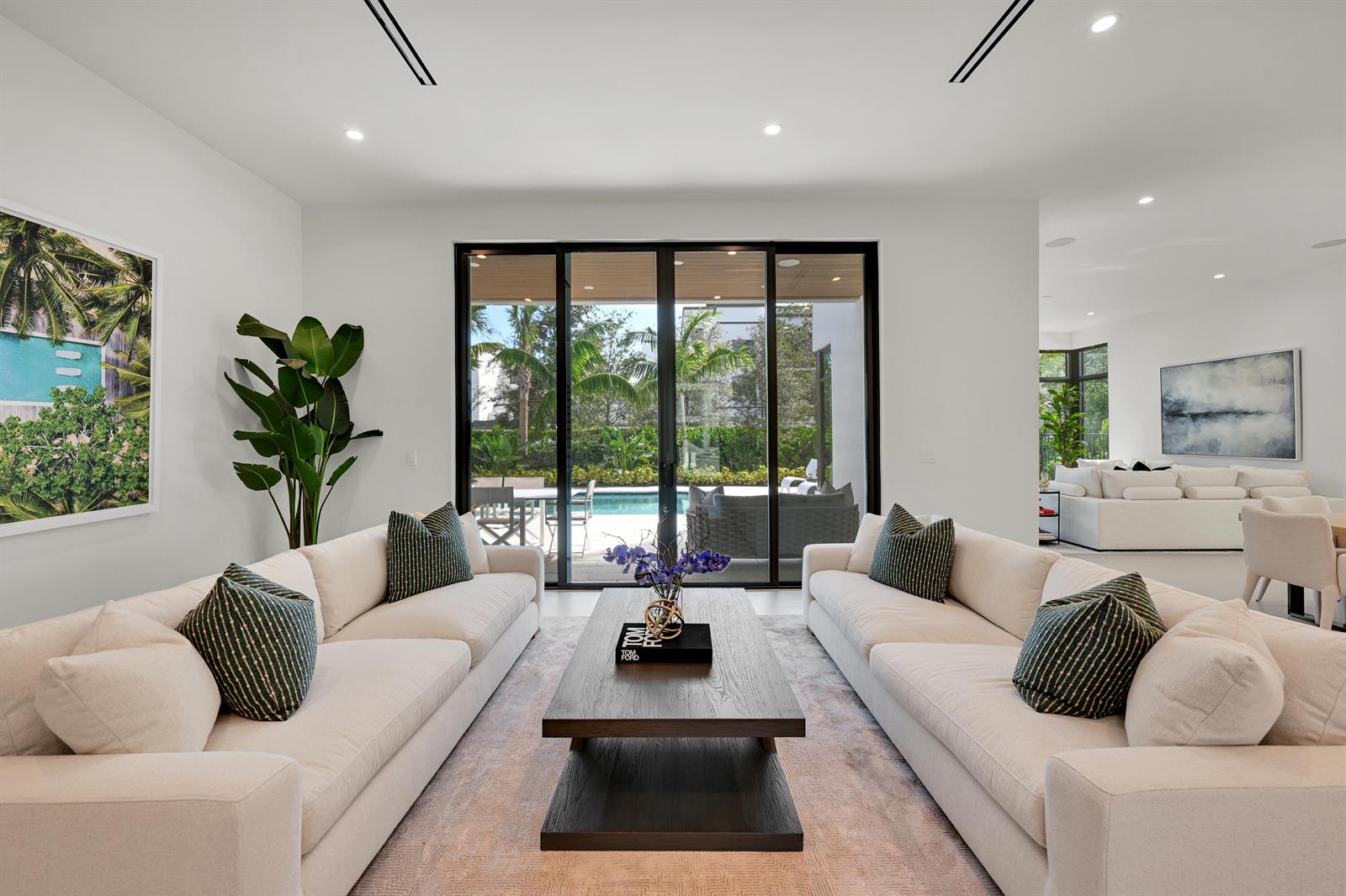A living room features two white sofas, a dark wood coffee table, and sliding glass doors — 16709 Mosaic Place, Delray Beach FL 33446, DELRAY BEACH, FL