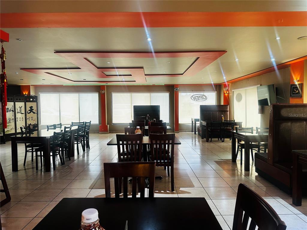 The interior of a restaurant features tiled floors, dark wooden furniture, and a recessed ceiling — 1260 CORNER CORCHADO ST., SANTURCE WARD, SAN JUAN, PR