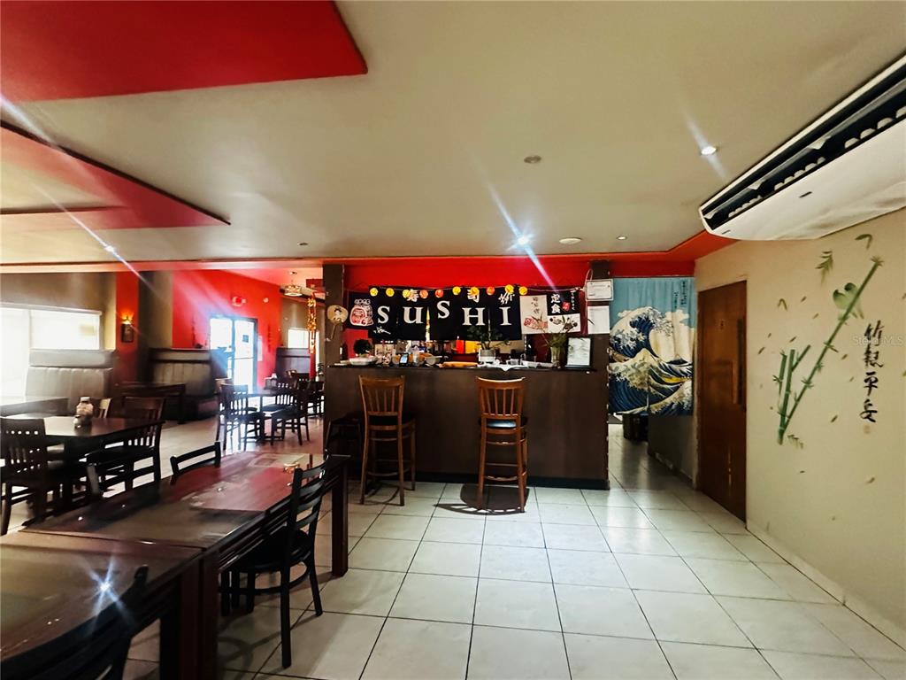 A restaurant interior features a sushi bar, wooden tables, chairs, and tiled flooring — 1260 CORNER CORCHADO ST., SANTURCE WARD, SAN JUAN, PR