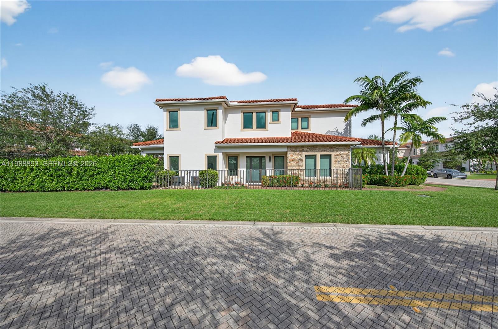 A two-story house with a tile roof, stone accents, and a fenced yard — 5999 E Brookfield Cir E, Hollywood FL 33312, HOLLYWOOD, FL