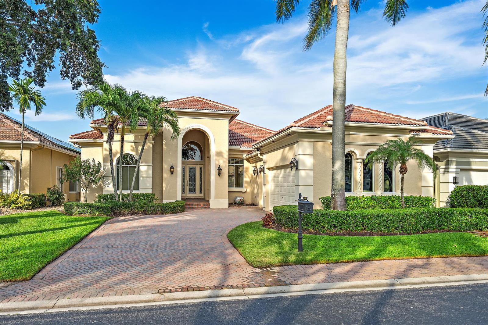 A single-story stucco house with a tiled roof, arched entryway, and a brick paver driveway — 7440 Monte Verde Lane, West Palm Beach FL 33412, WEST PALM BEACH, FL