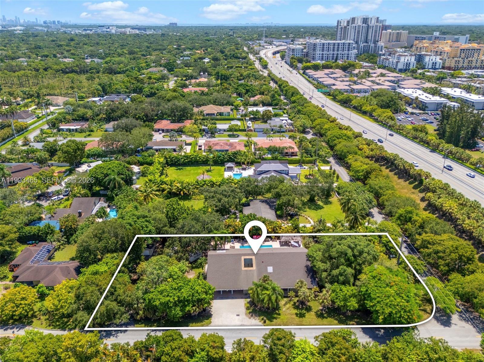 An aerial view shows a single-story house with a pool and large yard — 7997 SW 76th Avenue, Miami FL 33143, MIAMI, FL