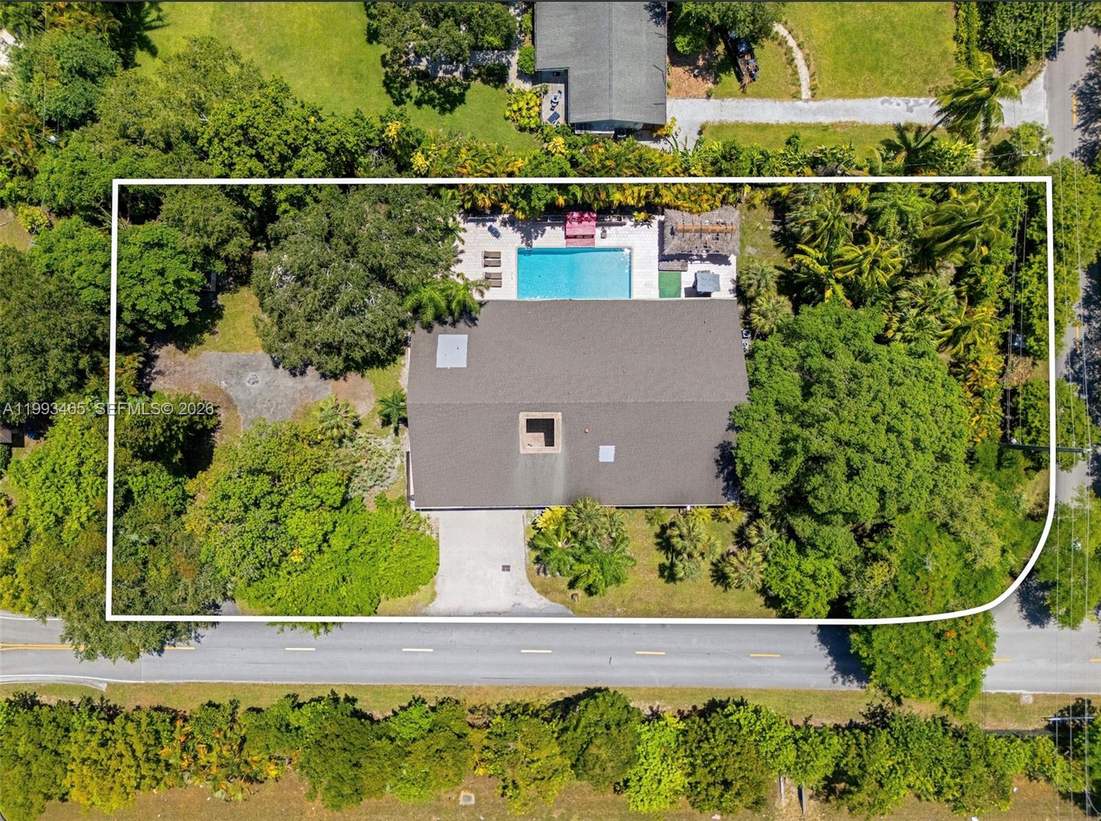 An aerial view shows a house with a pool and patio surrounded by dense trees — 7997 SW 76th Avenue, Miami FL 33143, MIAMI, FL