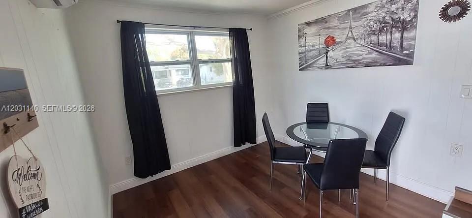 A dining area features a glass-topped table with four black chairs and dark wood flooring — 7860 SW 17th St # A, Miami FL 33155, MIAMI, FL