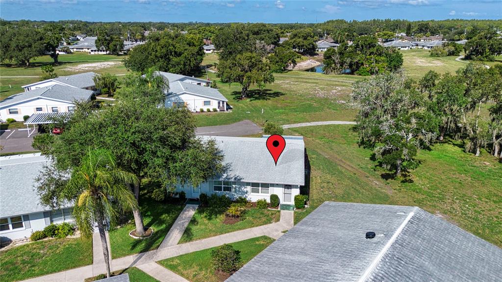 An aerial view shows a single-story residential building with a red location pin on top — 301 ANDOVER PLACE S UNIT 170, SUN CITY CENTER, FL