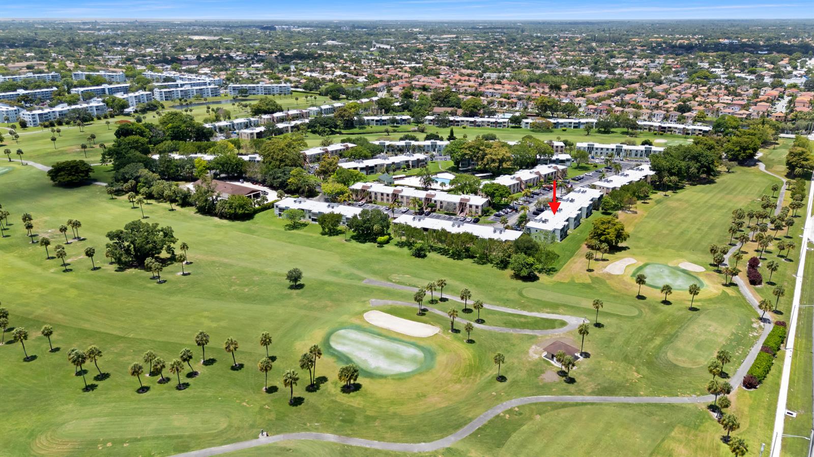 An aerial view shows a multi-story apartment complex situated on a green golf course — 7350 NW 18th Street # 207, Margate FL 33063, MARGATE, FL