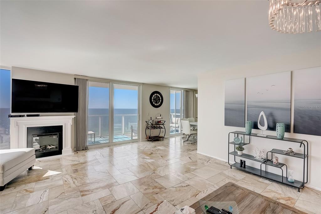 A living room features marble tile flooring, a fireplace, and a balcony with ocean views — 2425 GULF OF MEXICO DRIVE UNIT 14B, LONGBOAT KEY, FL