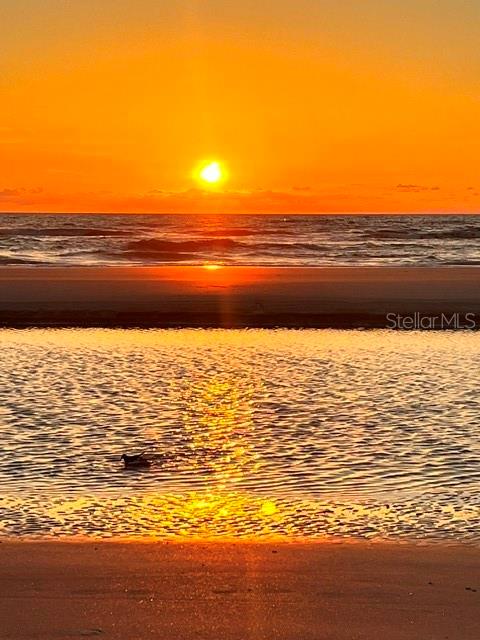 A studio apartment features a bed, a small desk, and an adjacent kitchen area — 935 S ATLANTIC AVE UNIT 255, DAYTONA BEACH, FL