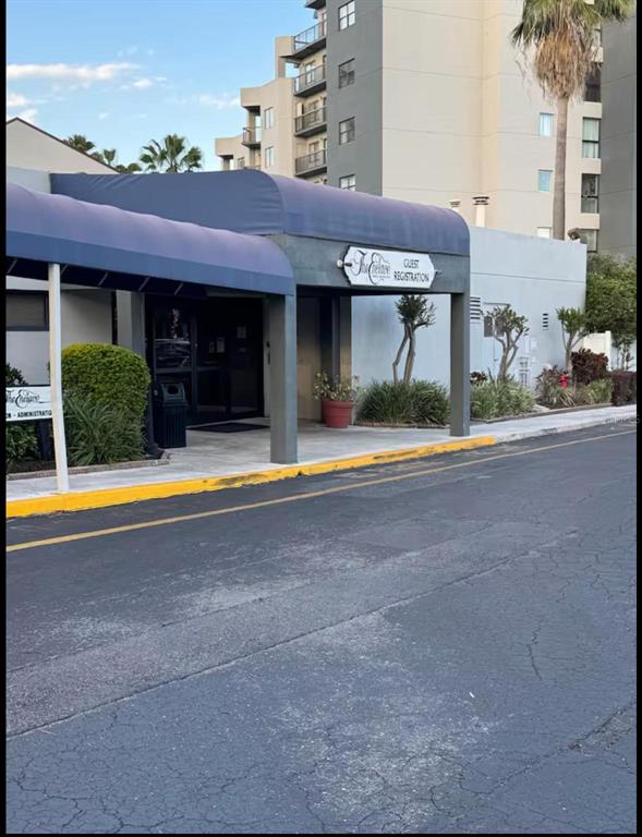 The exterior of a building features a blue awning over a guest registration entrance — 6165 CARRIER DRIVE UNIT 3104, ORLANDO, FL